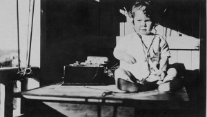 800px-StateLibQld_1_115508_Young_child_listening_to_a_radio,_1920-1930
