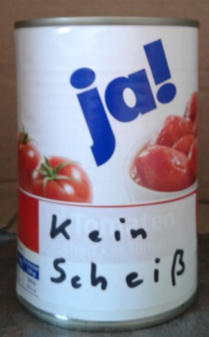 The can reads “no shit” in German, thus avoiding copyright infringement. “Kein Scheiß” in Germany means both  “no shit” and “I am not kidding you”. 